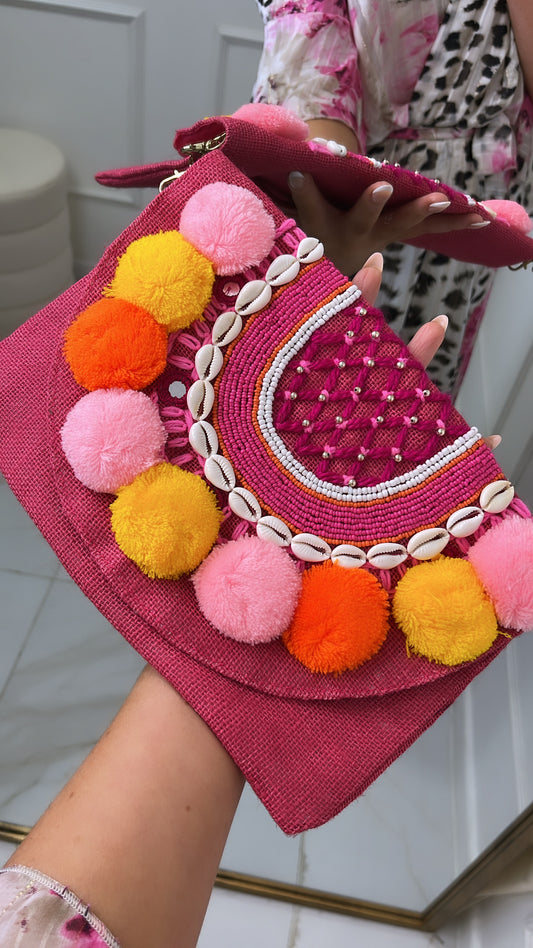 DARCIE pink pom pom shell clutch bag